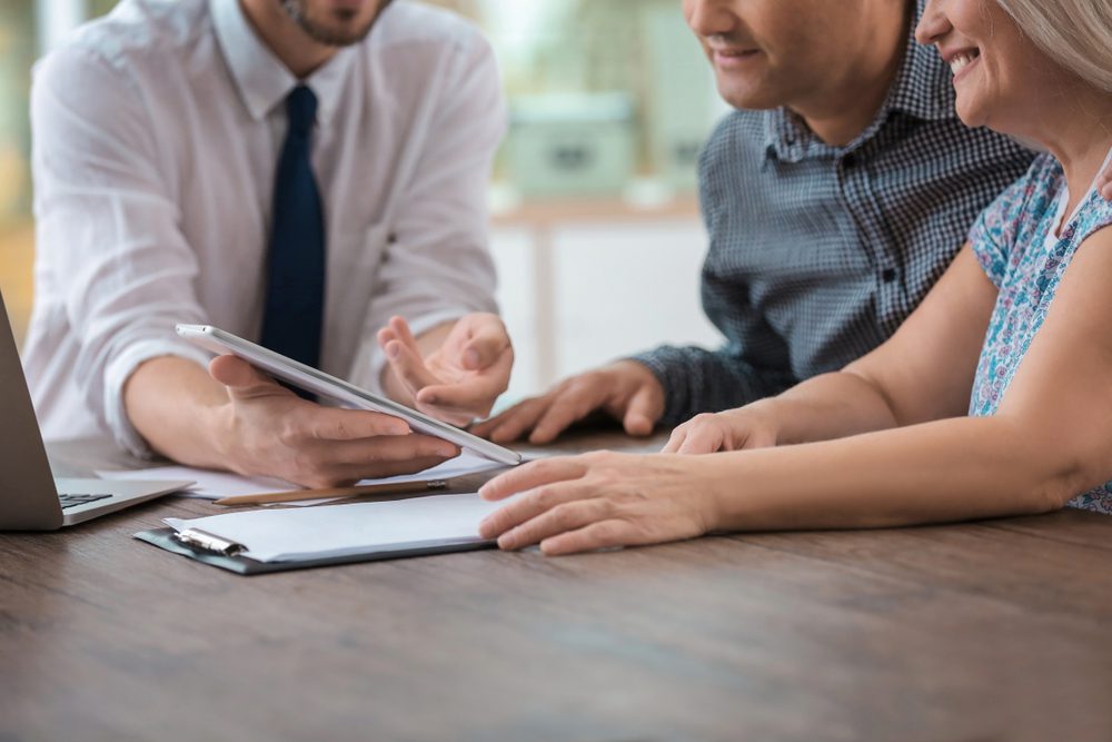 Male,Insurance,Agent,Consulting,Clients,In,Office